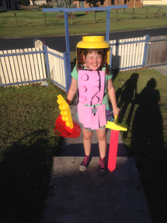 Chaos wants to scream at the sun as she shows off her Lego Warrior outfit. Helmet and shield are from Lego accessories and the sword and armour are made from craft foam and hot glue.